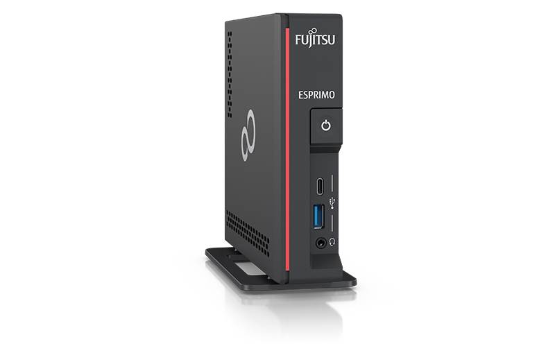 Mini komputer Fujitsu ESPRIMO w czarnej obudowie z czerwonym akcentem, pionowo na podstawce, z portami USB i gniazdem audio.