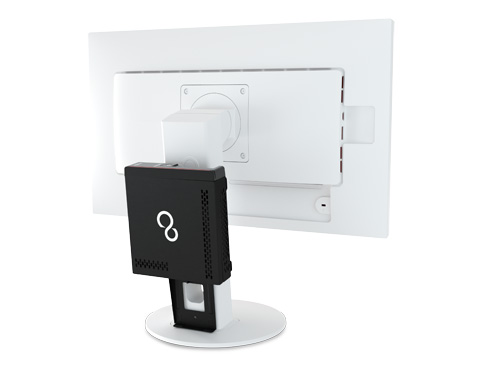Czarny mini PC Fujitsu zamontowany z tyłu białego monitora na podstawie, widok od tyłu.